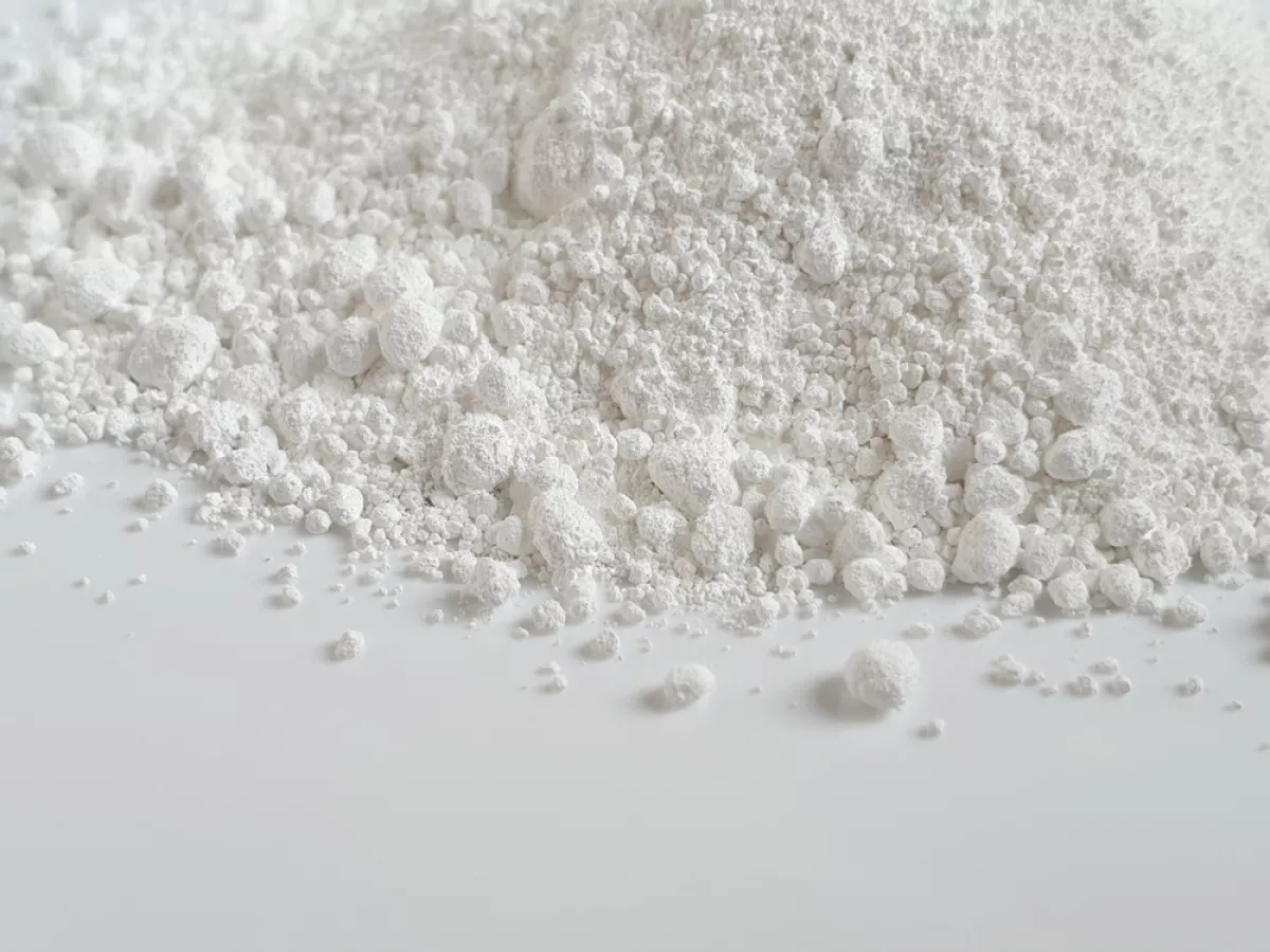 Titanium dioxide (TiO2) white powder on white surface